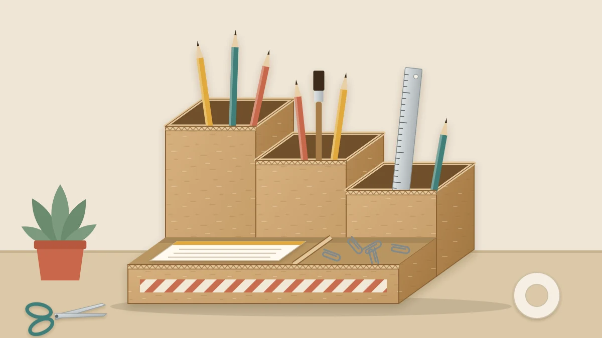 Cardboard desk organizer with three tall back compartments holding pencils and a ruler and a low front tray with paper clips