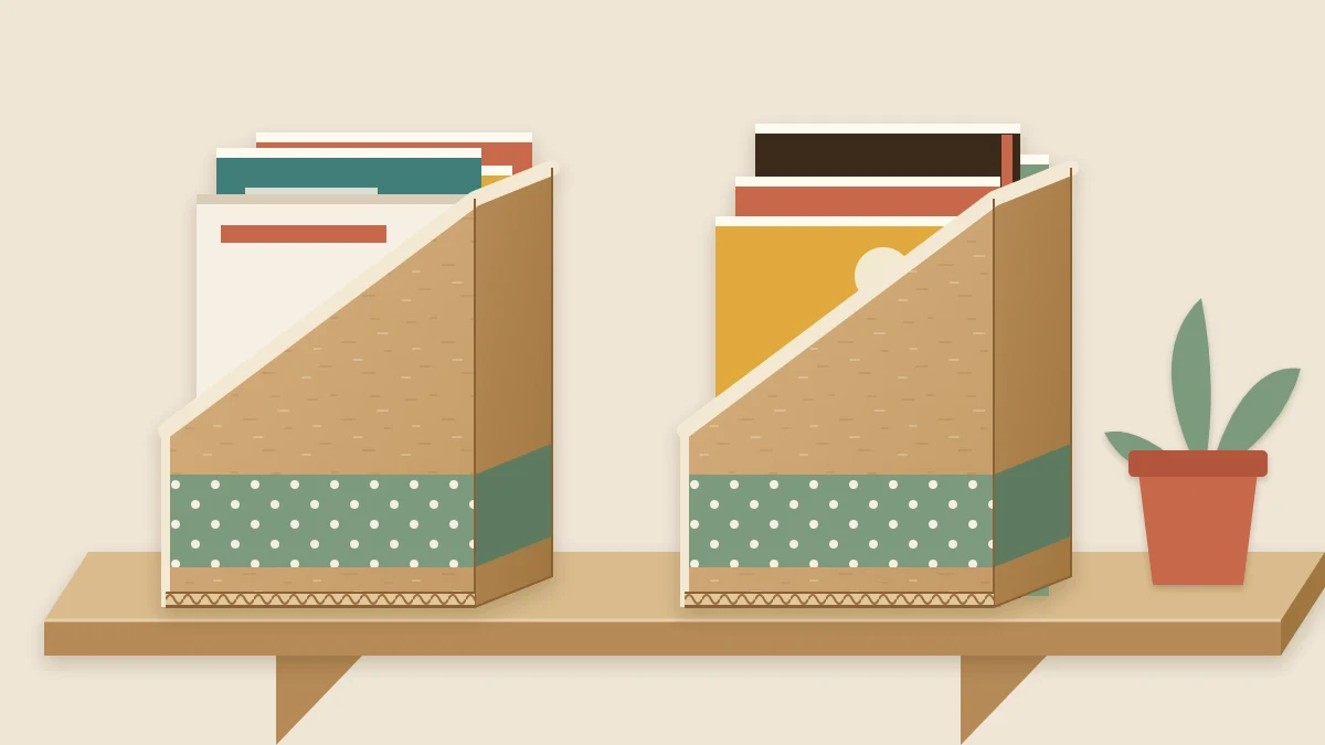 Two matching cardboard magazine holders with angled sides standing on a shelf, holding magazines and workbooks